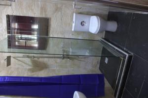 a bathroom with a toilet paper dispenser on a wall at The Vistana 4Bedroom Pearly Gate Estate Ikota VGC Lekki in Igboshere +13 photos