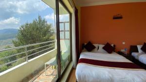 Postel nebo postele na pokoji v ubytování Hotel Nagarkot Inn