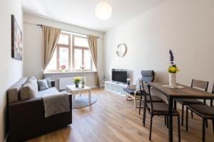 a living room with a table and a dining room at Macabu Apartment Marie in Zwickau