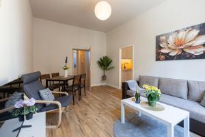 a living room with a couch and a table at Macabu Apartment Marie in Zwickau