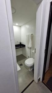 a bathroom with a white toilet in a room at Garvey 1101 - bela vista in Brasilia +14 photos