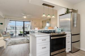 a kitchen with a stove and a refrigerator at A Piece of Heaven by Bryant Real Estate in Carolina Beach