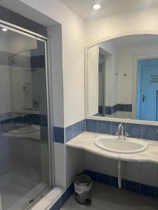 a bathroom with a sink and a shower and a mirror at Domina Coral Bay Aquamarine in Sharm El Sheikh +22 photos