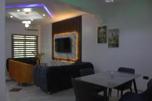 a living room with a couch and a table at The Vistana 4Bedroom Pearly Gate Estate Ikota VGC Lekki in Igboshere