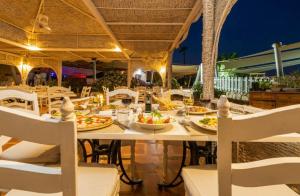 a dining table with plates of food on it at Domina Coral Bay Aquamarine in Sharm El Sheikh