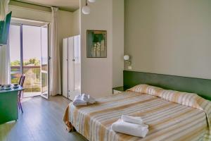Postel nebo postele na pokoji v ubytování Hotel Airone