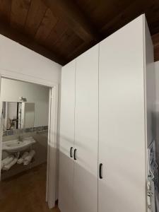 a bathroom with a white cabinet and a sink at Casette Comfort al mare - Ipanema Family Club Diamante in Diamante +2 photos