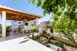 a patio with a garden on a roof at Apartments Ivica in Split