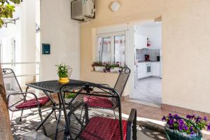 a balcony with a table and chairs and a kitchen at Apartments Ivica in Split