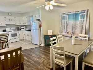 a kitchen with a dining table and a refrigerator at Seacoast Retreat in Long Beach
