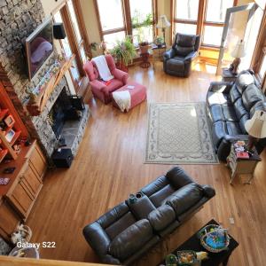 an overhead view of a living room with leather furniture at The Manor at Becks Lake in Rockmart