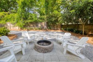 a group of white chairs sitting around a fire pit at Spacious Charleston - 6 mins to beach & Downtown in Charleston