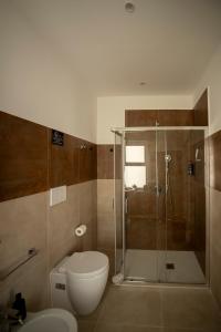 a bathroom with a shower and a toilet and a sink at Umberto Home 303 in Catania +70 photos