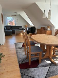a living room with a wooden table and chairs at Ferienwohnung Flensburg Mürwik in Flensburg