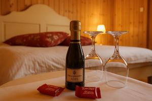 a bottle of wine and two glasses on a table at Aithra Boutique Suites in Tsivlós