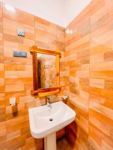 a bathroom with a sink and a mirror at Peak Bay Resort in Arugam Bay