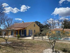 a yellow house with trees in front of it at La Cheneraie in Artignosc-sur-Verdon