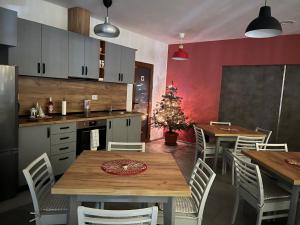 a kitchen with a table and chairs and a christmas tree at Villa YoSi in Sapareva Banya