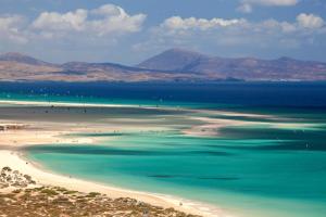 a view of a beach with people in the water at Occidental Jandía Mar in Morro del Jable