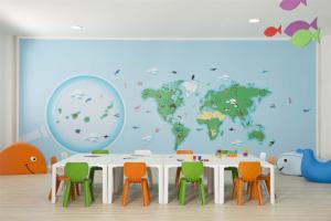 a room with a table and a world map mural at Occidental Jandía Mar in Morro del Jable