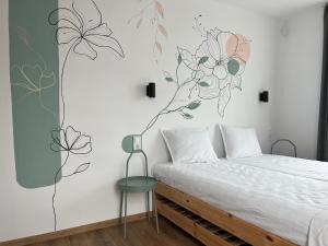 a bedroom with a bed with a flower mural on the wall at Villa YoSi in Sapareva Banya