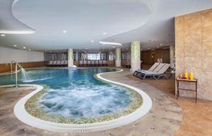 a large pool with a water feature in a hotel room at Occidental Jandía Mar in Morro del Jable