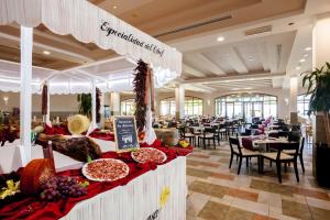 a buffet line with food on display in a restaurant at Occidental Jandía Mar in Morro del Jable