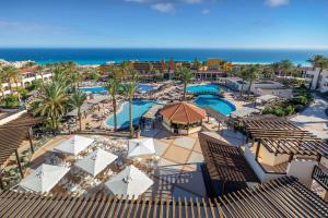 an aerial view of a resort with a pool and the ocean at Occidental Jandía Mar in Morro del Jable