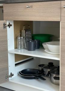 a shelf with pots and pans in a kitchen at Appartamenti La Patria dei Poeti in Castel San Giovanni