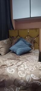 a bed with a blue pillow on top of it at Asta room in Sabkhah +21 photos