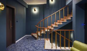 a staircase in a house with blue walls at The Oscar Olympic Hotel in Thessaloniki