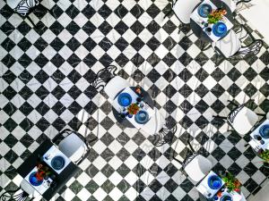 an overhead view of a checkered floor with cars on it at The Oscar Olympic Hotel in Thessaloniki
