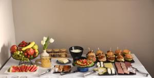 a table with sandwiches and other food on it at The Oscar Olympic Hotel in Thessaloniki