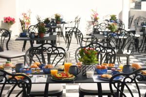 a table with breakfast foods and orange juice on it at The Oscar Olympic Hotel in Thessaloniki