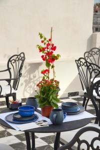 a table with blue dishes and a plant on it at The Oscar Olympic Hotel in Thessaloniki
