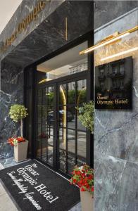 a entrance to a hotel with a sign on the door at The Oscar Olympic Hotel in Thessaloniki