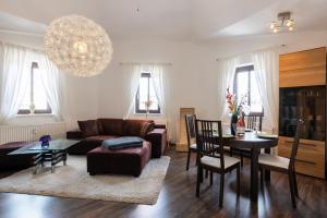 a living room with a couch and a table at Macabu Premium Apartment Joker,Chemnitz in Chemnitz