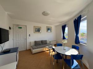 a living room with a couch and a table at Apartments & Restaurant Condura Croatica Nin-Sabunike in Nin