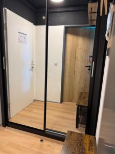 a sliding glass door in a room with a wooden floor at Bavaria Oasis in Altreichenau