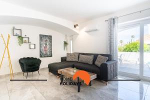 a living room with a couch and a table at #268 Luxury Villa Pool & Views in Albufeira