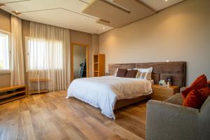 a bedroom with a large bed and a couch at Best 4 Bedroom Luxury Villa In Mediouna in Jbila +33 photos