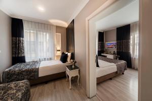 a hotel room with two beds and a window at Beyazit Palace Hotel in Istanbul