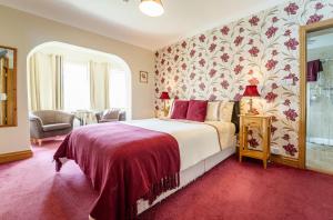 a bedroom with a bed with a red carpet at Bertra House B&B in Westport