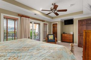 a bedroom with a bed and a ceiling fan at CSC3E Afternoon Delight in Kill Devil Hills +40 photos