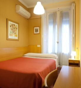 Postel nebo postele na pokoji v ubytování Hostal Prim