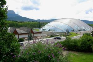 a large greenhouse with a car parked in front of it at Hotel El Acebo in Jaca