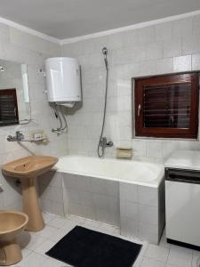 a bathroom with a tub and a toilet and a sink at Vila Bojana in Gornji Milanovac +14 photos