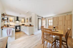a kitchen and dining room with a table and chairs at Bramble Bank in Dorchester