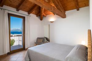 a bedroom with a bed and a large window at Bellosguardo 3, 8 - Klodge in Olbia +50 photos