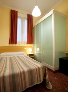 Postel nebo postele na pokoji v ubytování Hostal Prim